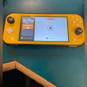 Nintendo switch lite with original charger and mario deluxe game included